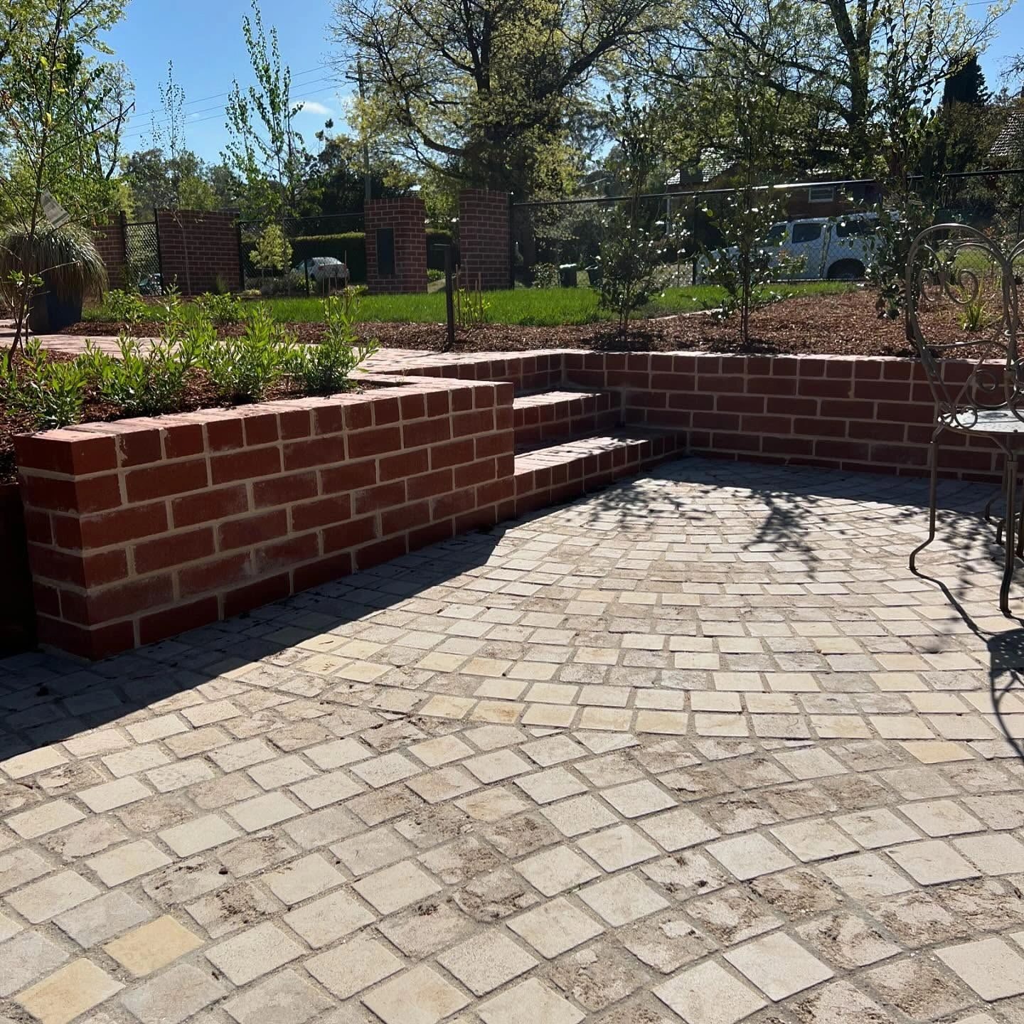 Brick paved courtyard with brick edging walls