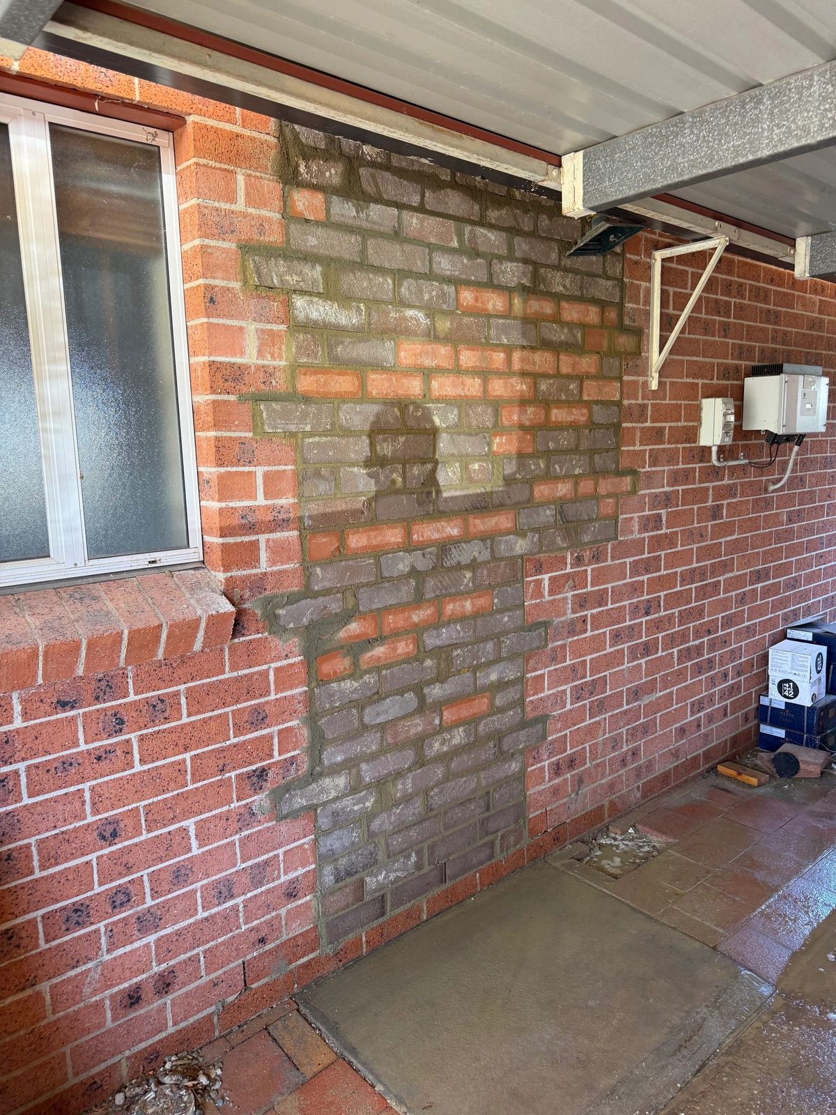 Weathered brick wall needing repair and repointing